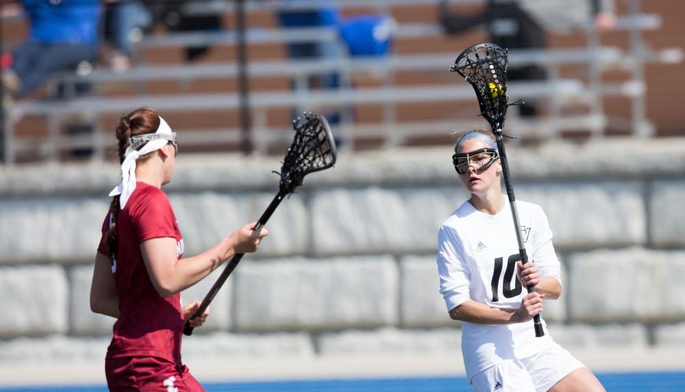 GVL / Kevin Sielaff – Chelsey Bishop (10) holds the ball and passes it behind Indianapolis' net. The Lakers defeat the Greyhounds of the University of Indianapolis Saturday, March 26, 2016 with a final score of 15-4.