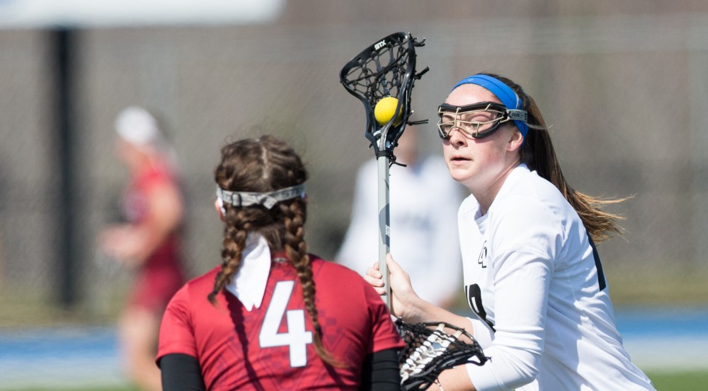 GVL / Kevin Sielaff – Meghan Datema (18) moves the ball up field. The Lakers defeat the Greyhounds of the University of Indianapolis Saturday, March 26, 2016 with a final score of 15-4.