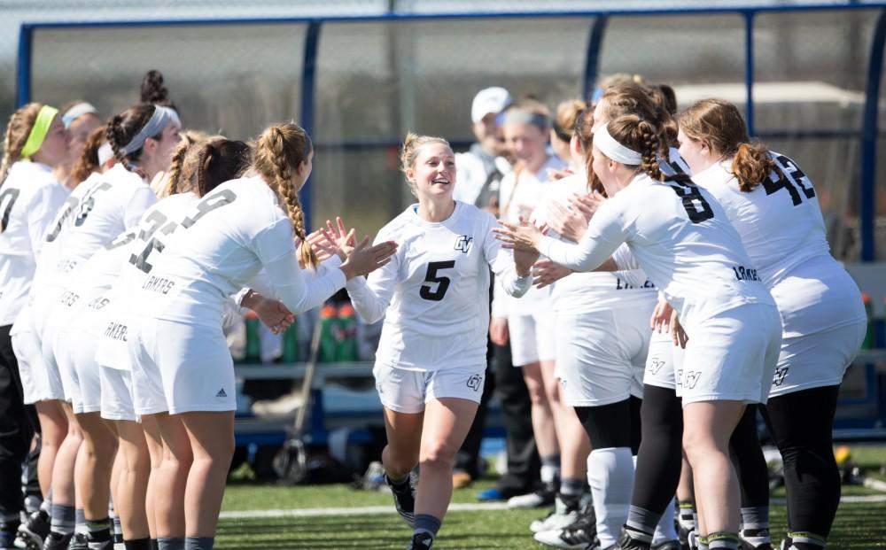 GVL / Kevin Sielaff – Kelly Leibovitz (5) runs onto the field as the starting line-up is called. The Lakers defeat the Bearcats of McKendree University with a final score of 23-11 Friday, March 25, 2016 in Allendale.