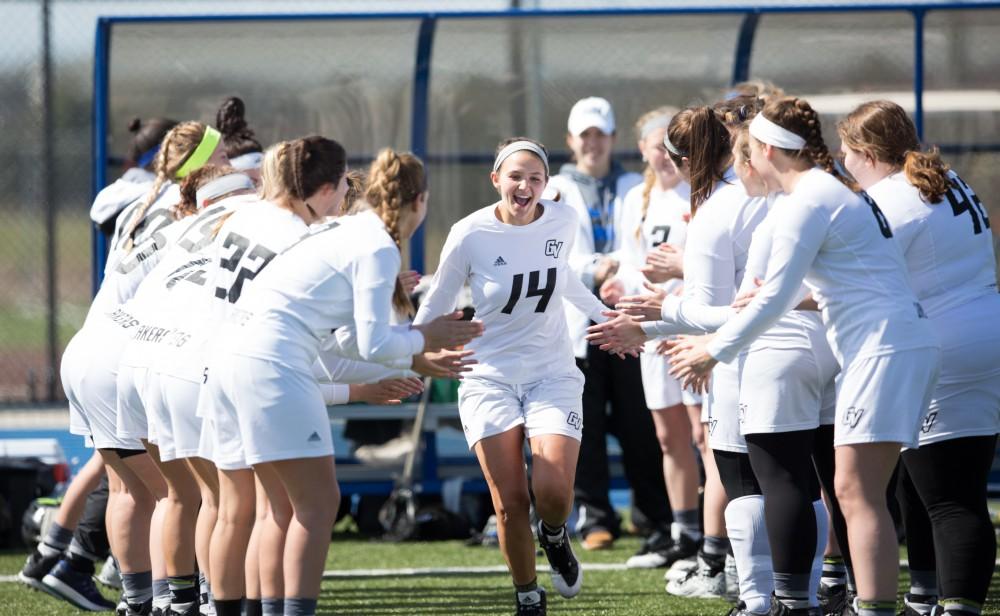 GVL / Kevin Sielaff – Chloe Zdybel (14) runs onto the field as the starting line-up is called. The Lakers defeat the Bearcats of McKendree University with a final score of 23-11 Friday, March 25, 2016 in Allendale.