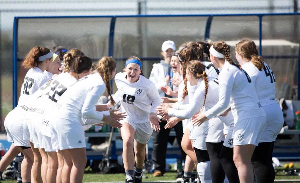 GVL / Kevin Sielaff – Meghan Datema (18) runs onto the field as the starting line-up is called. The Lakers defeat the Bearcats of McKendree University with a final score of 23-11 Friday, March 25, 2016 in Allendale.