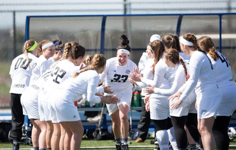 GVL / Kevin Sielaff – Caitlin Wojichowski (33) runs onto the field as the starting line-up is called. The Lakers defeat the Bearcats of McKendree University with a final score of 23-11 Friday, March 25, 2016 in Allendale.