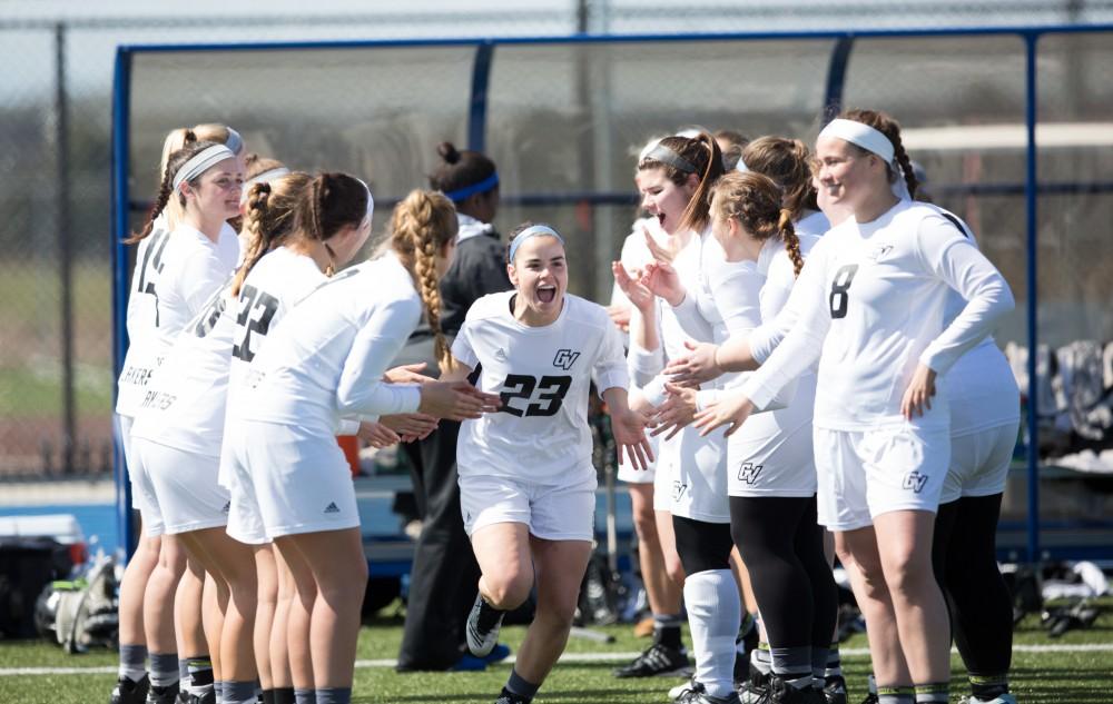 GVL / Kevin Sielaff – Carolyn Kraus (23) runs onto the field as the starting line-up is called. The Lakers defeat the Bearcats of McKendree University with a final score of 23-11 Friday, March 25, 2016 in Allendale.