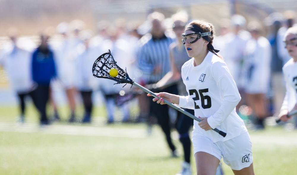 GVL / Kevin Sielaff – Katie Tomlinson (26) moves the ball up field. The Lakers defeat the Bearcats of McKendree University with a final score of 23-11 Friday, March 25, 2016 in Allendale.