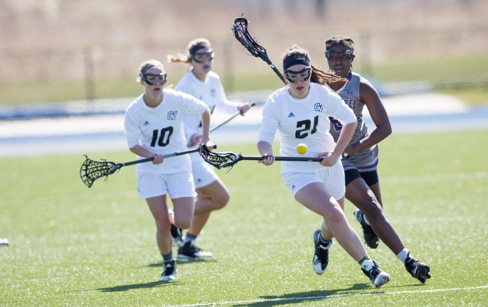 GVL / Kevin Sielaff – Kelley Fitzgerald (21) runs to pick up the ball at mid-field. The Lakers defeat the Bearcats of McKendree University with a final score of 23-11 Friday, March 25, 2016 in Allendale.