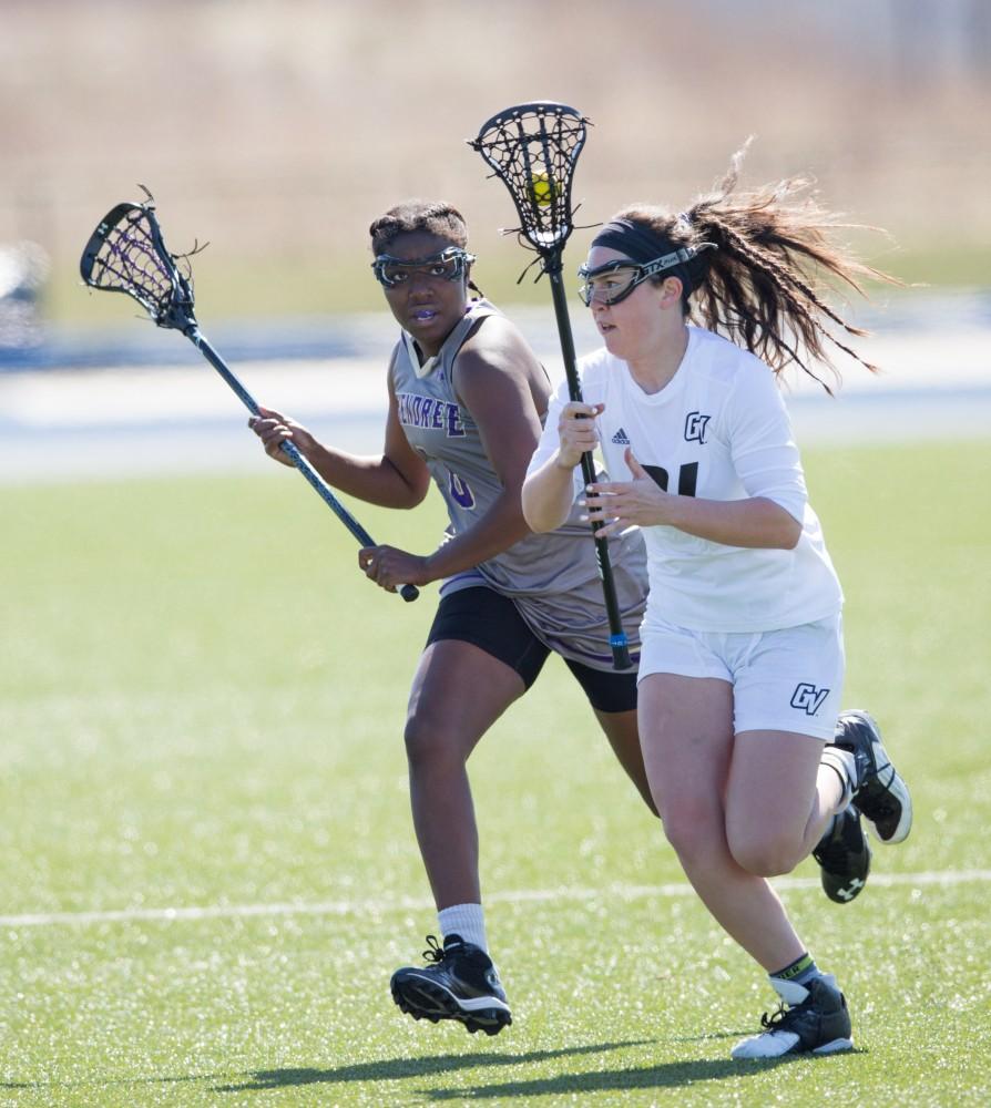 GVL / Kevin Sielaff – Kelley Fitzgerald picks up a loose ball at mid-field and moves the ball into McKendree's zone. The Lakers defeat the Bearcats of McKendree University with a final score of 23-11 Friday, March 25, 2016 in Allendale.