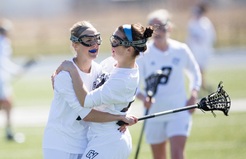 GVL / Kevin Sielaff – Chelsey Bishop (10) and Carolyn Kraus (23) celebrate a goal. The Lakers defeat the Bearcats of McKendree University with a final score of 23-11 Friday, March 25, 2016 in Allendale.