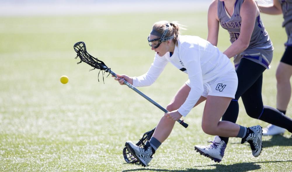 GVL / Kevin Sielaff – Kelly Leibovitz (5) tries to pick up a loose ball at mid-field. The Lakers defeat the Bearcats of McKendree University with a final score of 23-11 Friday, March 25, 2016 in Allendale.