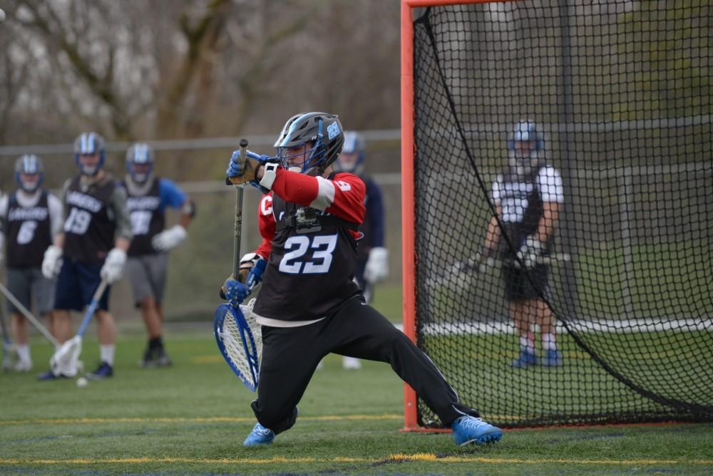 GVL / Luke Holmes - Sports Editor, Adam Knorr, takes on the challenge of being a lacrosse goalie at the turf field Tuesday, April 19, 2016.