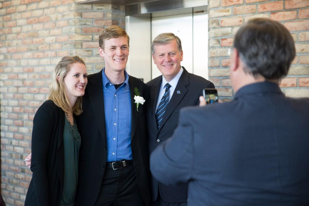 GVL / Luke Holmes - A couple of students pose for a photo with president Haas before the ceremony. The Student Convocation awards ceremony was held in the Eberhard Center Monday, Apr. 11, 2016.
