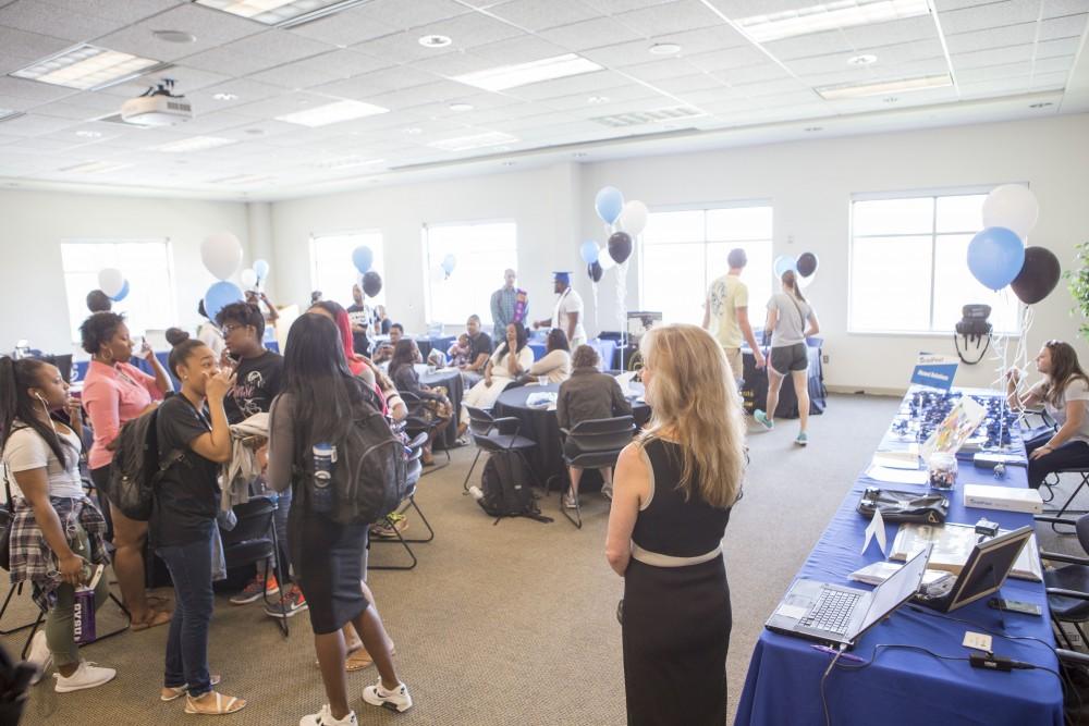 GVL / Sara Carte - Seniors attend GradFest to get their pictures taken, pick up cap and gowns, and win free prizes in the Kirkhof Center on Monday, Apr. 18, 2016.