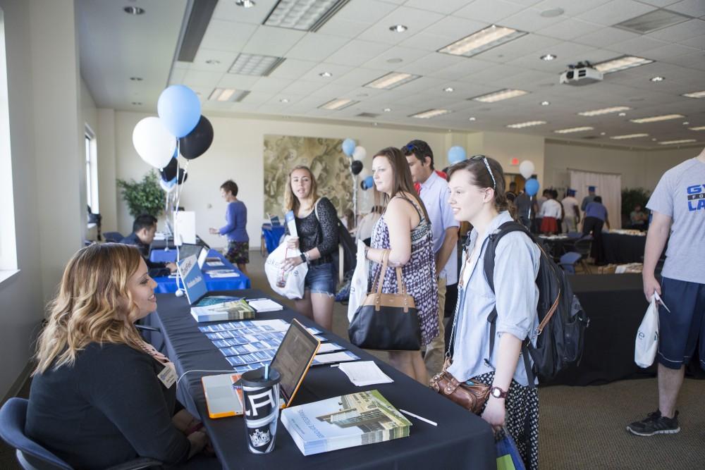 GVL / Sara Carte - Seniors attend GradFest to get their pictures taken, pick up cap and gowns, and win free prizes in the Kirkhof Center on Monday, Apr. 18, 2016.