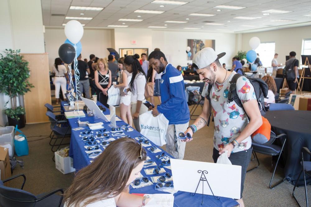 GVL / Sara Carte - Seniors recieve free sunglasses and car decals at GradFest in the Kirkhof Center on Monday, Apr. 18, 2016.