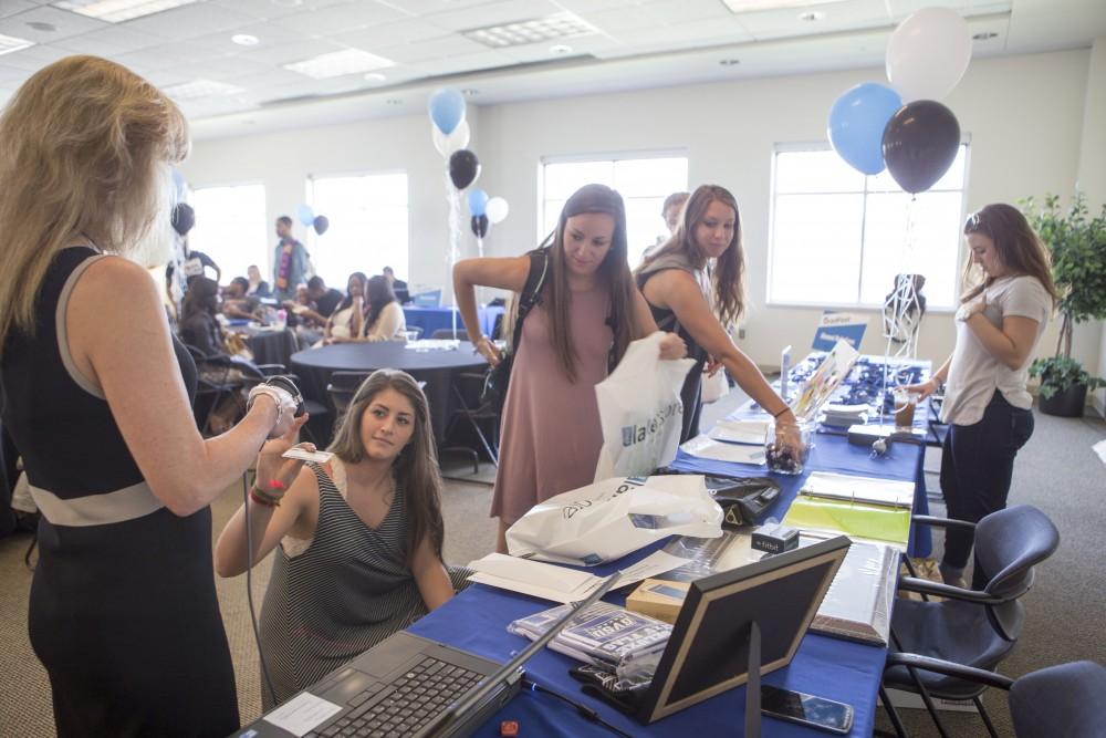 GVL / Sara Carte - Seniors get their student ID’s scanned to win free prizes at GradFest in the Kirkhof Center on Monday, Apr. 18, 2016.