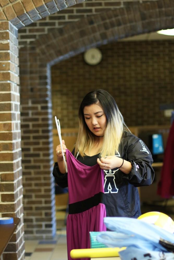 GVL / Kasey Garvelink - Jenna Bradshaw helps hang up clothing that the Greek Closet event received on Apr. 12, 2016 in Allendale. 
