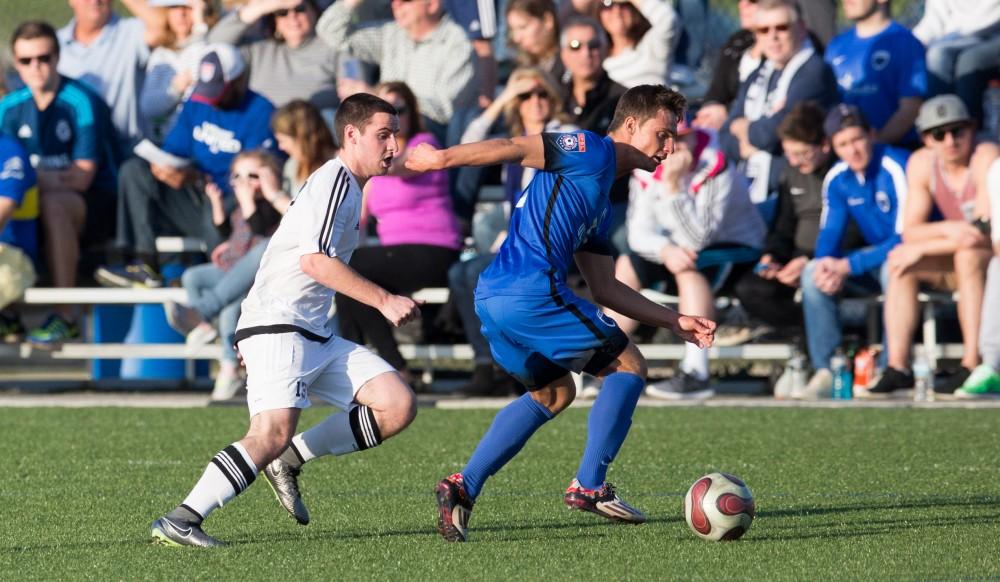 GVL / Kevin Sielaff - Robert Klein (13) runs after the ball as GRFC steals it at mid-field. Grand Valley's men's club soccer team falls to GRFC with a final score of 2-0 on Friday, April 15, 2016.