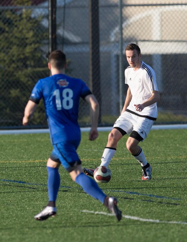 GVL / Kevin Sielaff - Grant Cooperrider (4) plays the ball in Grand Valley's zone. Grand Valley's men's club soccer team falls to GRFC with a final score of 2-0 on Friday, April 15, 2016.