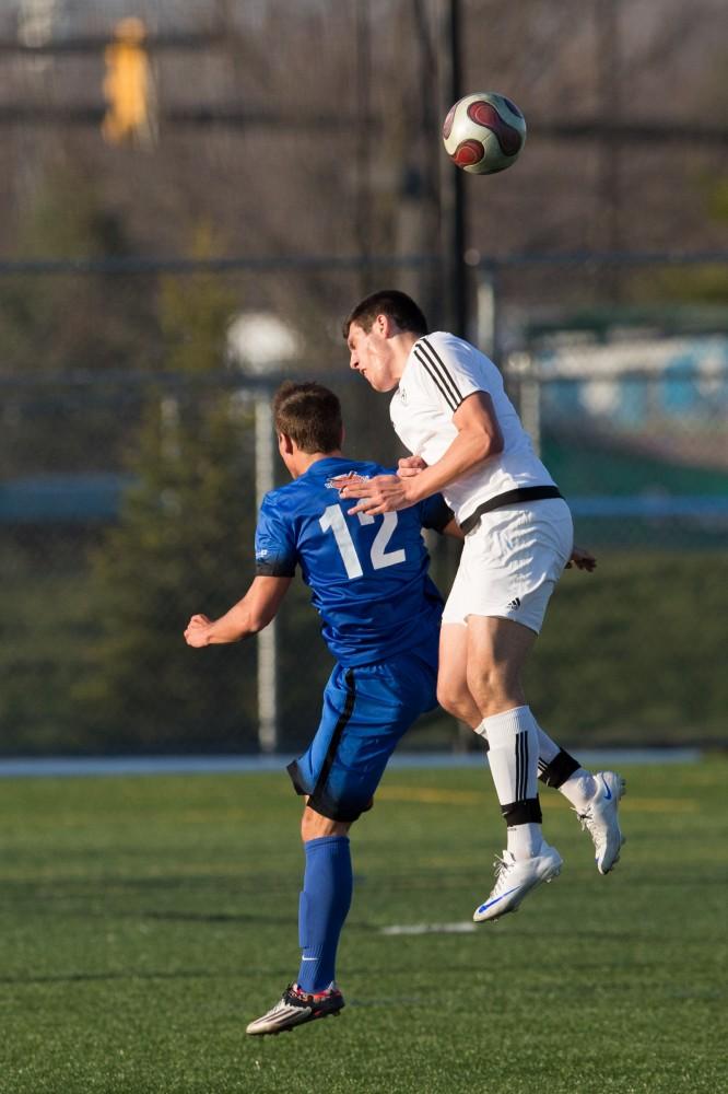 GVL / Kevin Sielaff - Casey Hagan (12) heads the ball at mid-field. Grand Valley's men's club soccer team falls to GRFC with a final score of 2-0 on Friday, April 15, 2016.