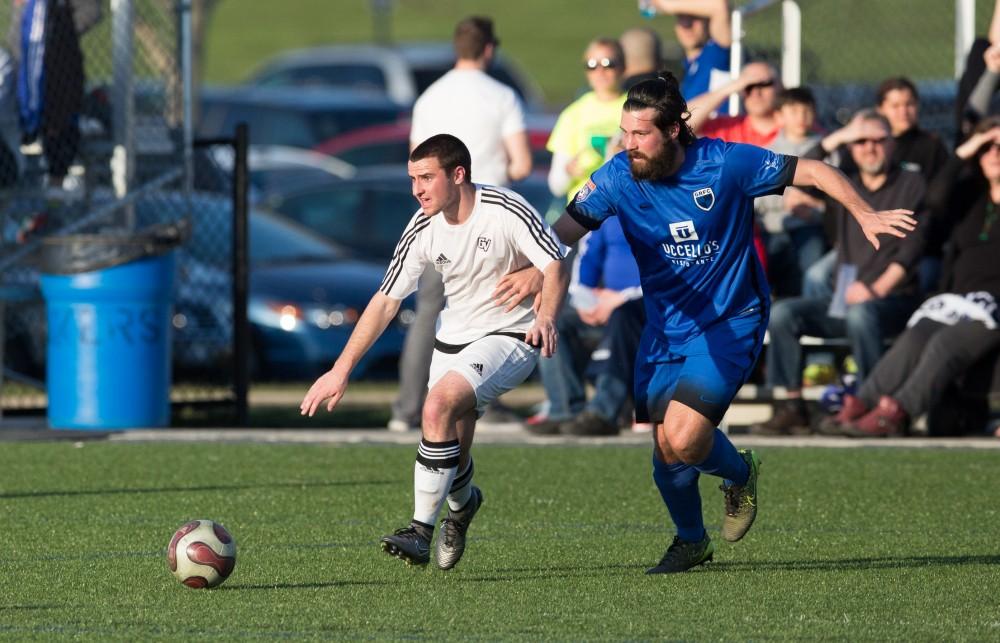 GVL / Kevin Sielaff - Robert Klein (13) fights for to maintain of posession of the ball. Grand Valley's men's club soccer team falls to GRFC with a final score of 2-0 on Friday, April 15, 2016.