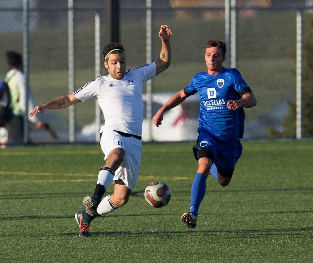 GVL / Kevin Sielaff - Eric Towns (11) runs up to make contact with the ball before the GRFC offense. Grand Valley's men's club soccer team falls to GRFC with a final score of 2-0 on Friday, April 15, 2016.