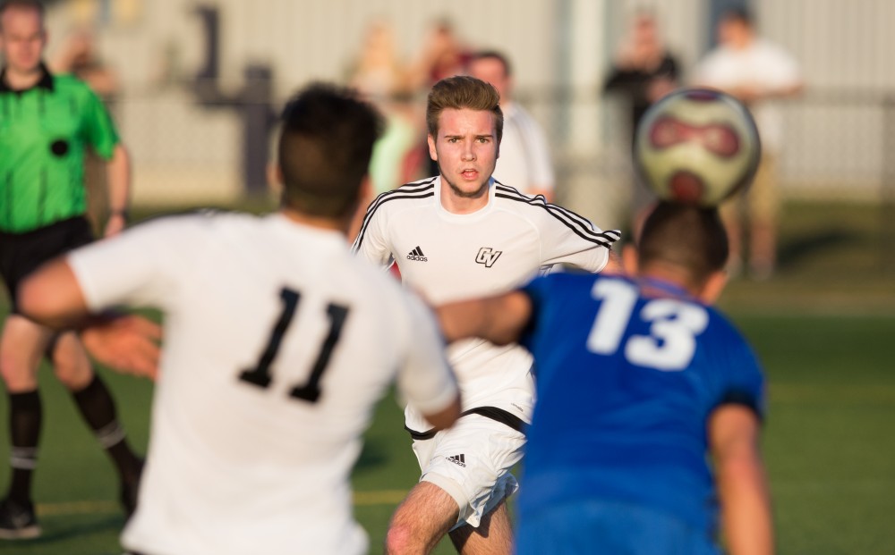 GVL / Kevin Sielaff - Garrett Cooperrider (14) runs after the ball as GRFC heads it away. Grand Valley's men's club soccer team falls to GRFC with a final score of 2-0 on Friday, April 15, 2016.