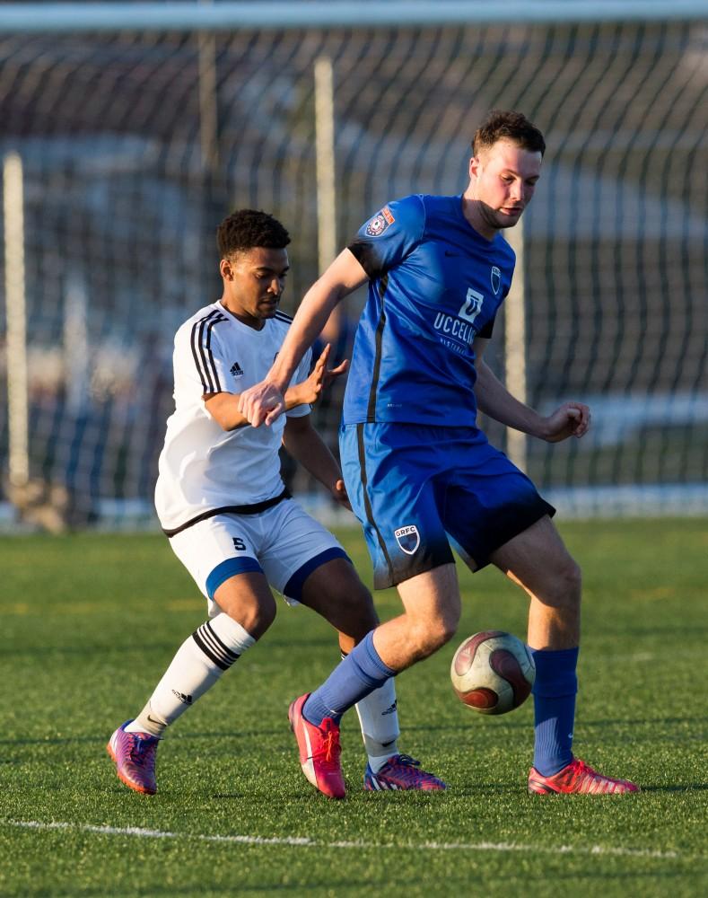 GVL / Kevin Sielaff - Wilfred Simmons (5) defends the ball from a GRFC attack. Grand Valley's men's club soccer team falls to GRFC with a final score of 2-0 on Friday, April 15, 2016.