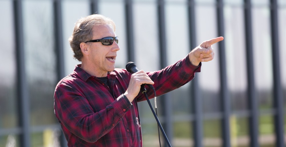 GVL / Kevin Sielaff - Assistant Professor of Liberal Studies Brent Smith speaks to the crowd before the start of the celebration. Grand Valley celebrates India’s spring color festival, Holi, for the first time on Friday, April 15, 2016.