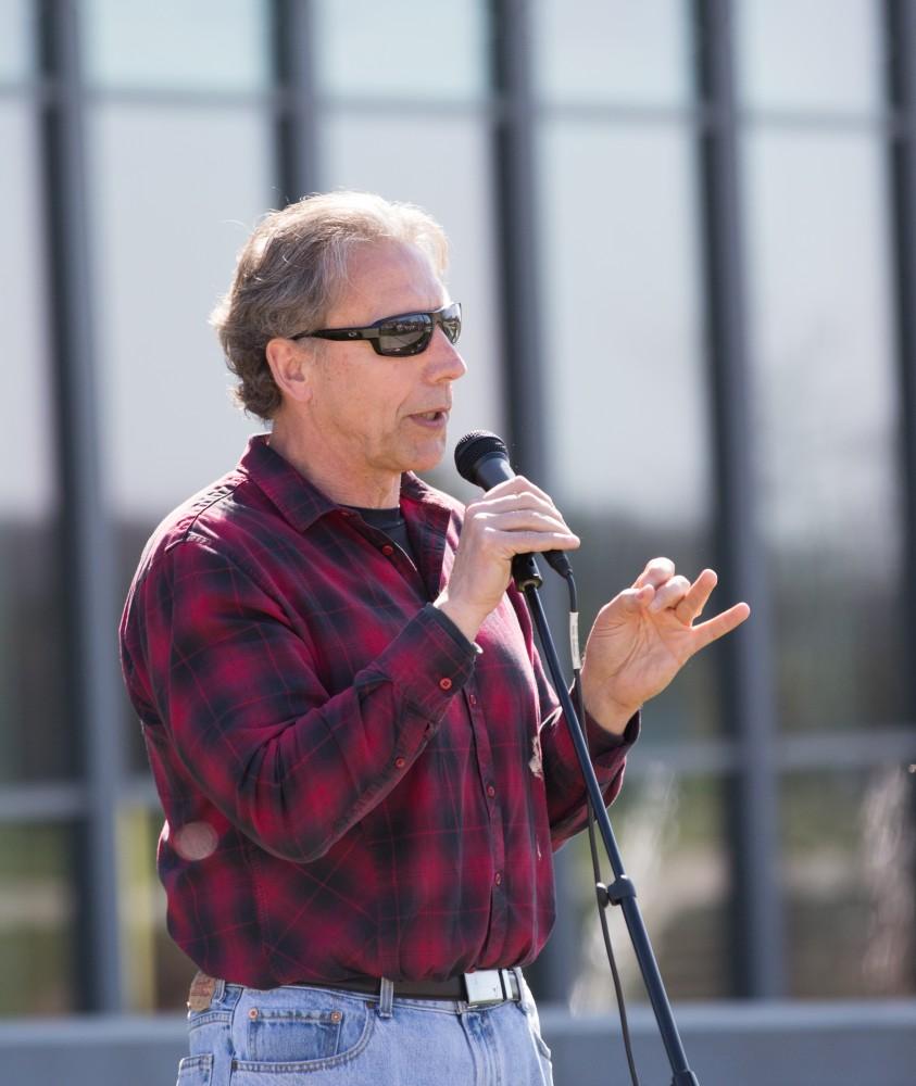 GVL / Kevin Sielaff - Assistant Professor of Liberal Studies Brent Smith speaks to the crowd before the start of the celebration. Grand Valley celebrates India’s spring color festival, Holi, for the first time on Friday, April 15, 2016.