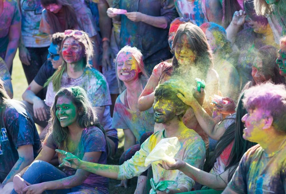 GVL / Kevin Sielaff - Jaimik Trivedi is dusted with yellow powder as the Holi celebrations come to a a close. Grand Valley celebrates India’s spring color festival, Holi, for the first time on Friday, April 15, 2016.