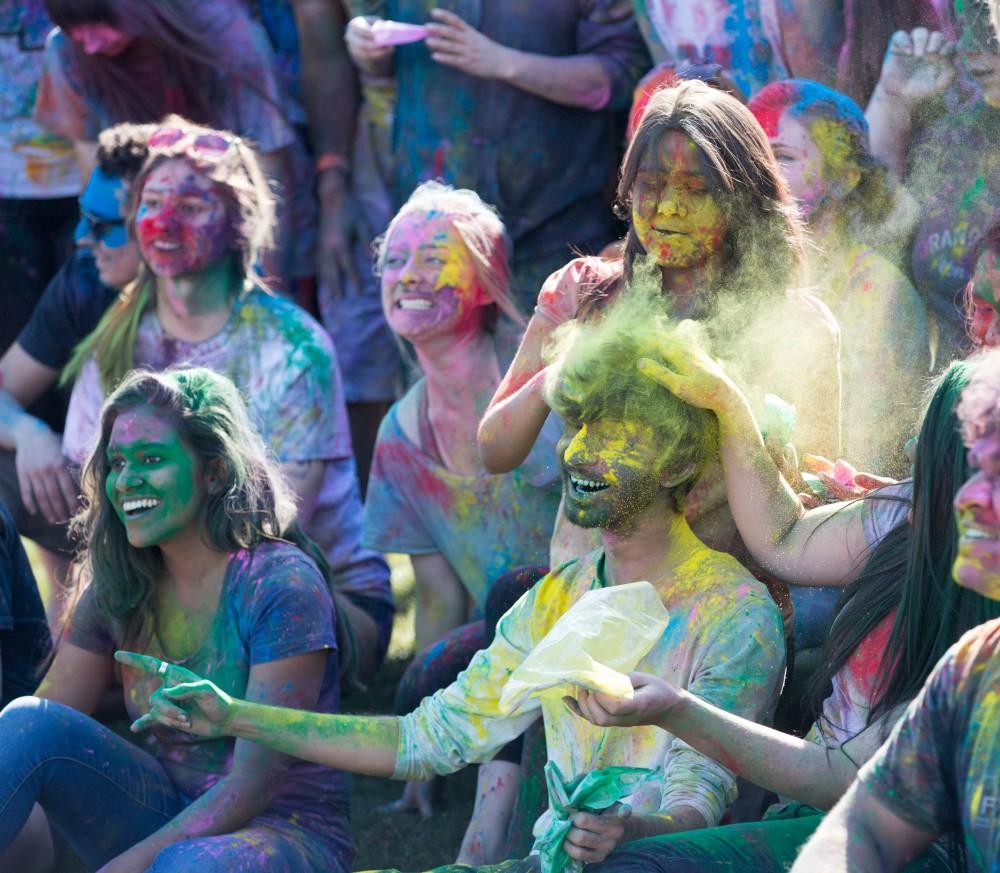 GVL / Kevin Sielaff - Jaimik Trivedi is dusted with yellow powder as the Holi celebrations come to a a close. Grand Valley celebrates India’s spring color festival, Holi, for the first time on Friday, April 15, 2016.