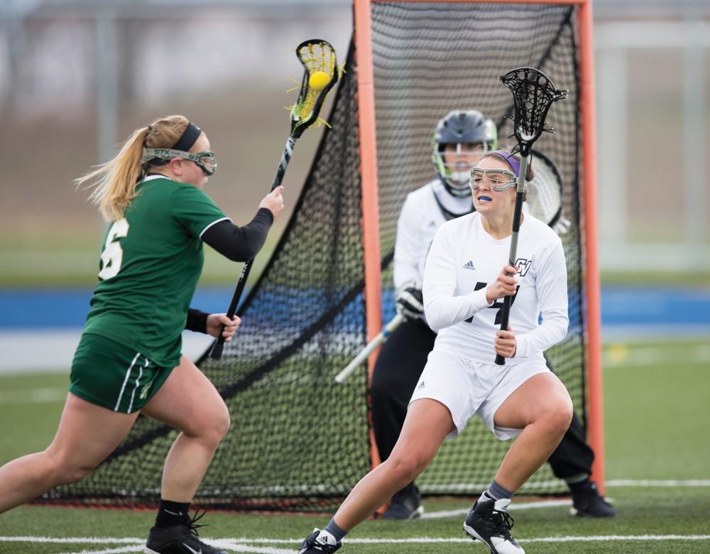 GVL / Kevin Sielaff – Chloe Zdybel (14) defends Grand Valleys net. The Lakers take the victory over Tiffin University Friday, April 1, 2016.