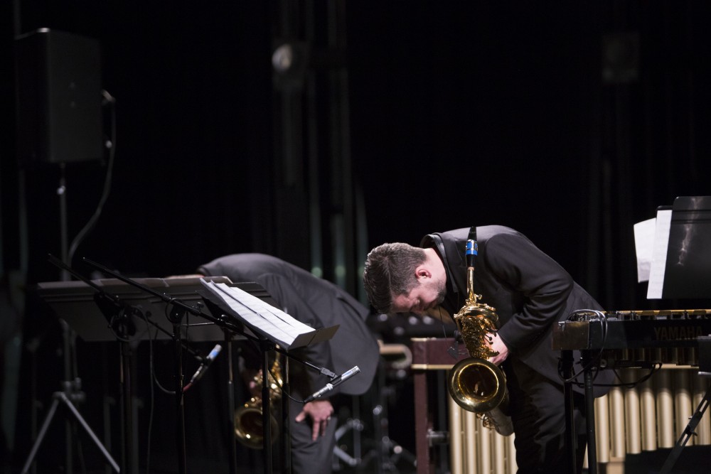 GVL / Sara Carte - Jonathan Nichol (left) and Geoffrey Deibel (right) bow at the end of their performance at the GVSU New Music Ensemble 10th Anniversary Concert to begin at the Peter Martin Wege Theatre in Grand Rapids on Saturday, Apr. 2, 2016.