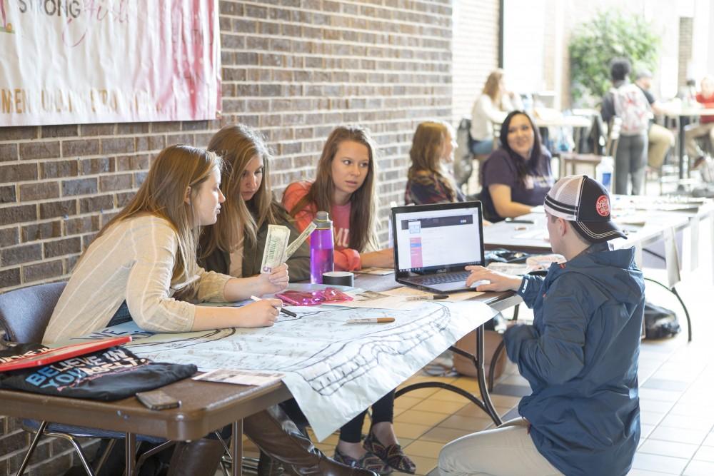 GVL / Sara Carte - Members of Gamma Phi Beta take donations for their Gamma Phive K run in the Kirkhof center on Monday, Apr. 11, 2016.