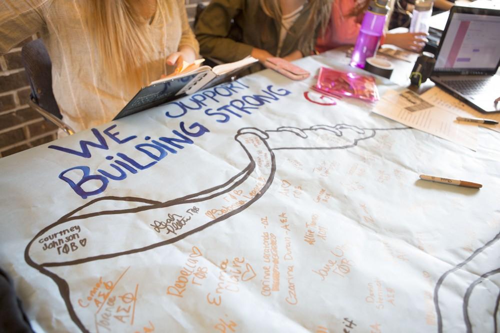 GVL / Sara Carte - Gamma Phi Beta sets up a booth for their Gamma Phive K run that is being held on April 17, in the Kirkhof center on Monday, Apr. 11, 2016.