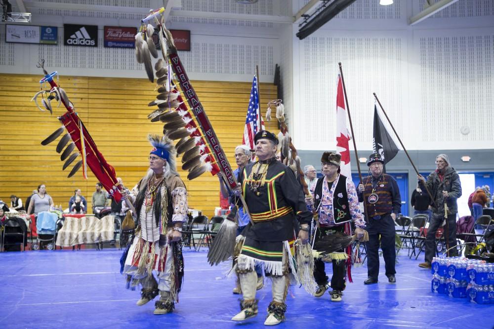 GVL / Sara Carte - Native American dancers start the Pow-Wow at the Native American Pow-Wow in the Fieldhouse on Saturday, Apr. 9, 2016.