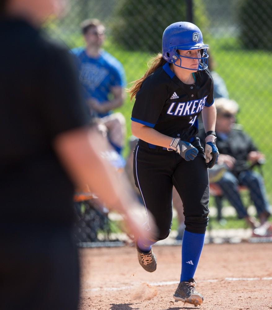 GVL / Kevin Sielaff – Jenna Lenza (4) hits a bouncing ball and runs to first base.  Grand Valley takes the victory over Walsh in both games held in Allendale on Saturday, April 23, 2016.