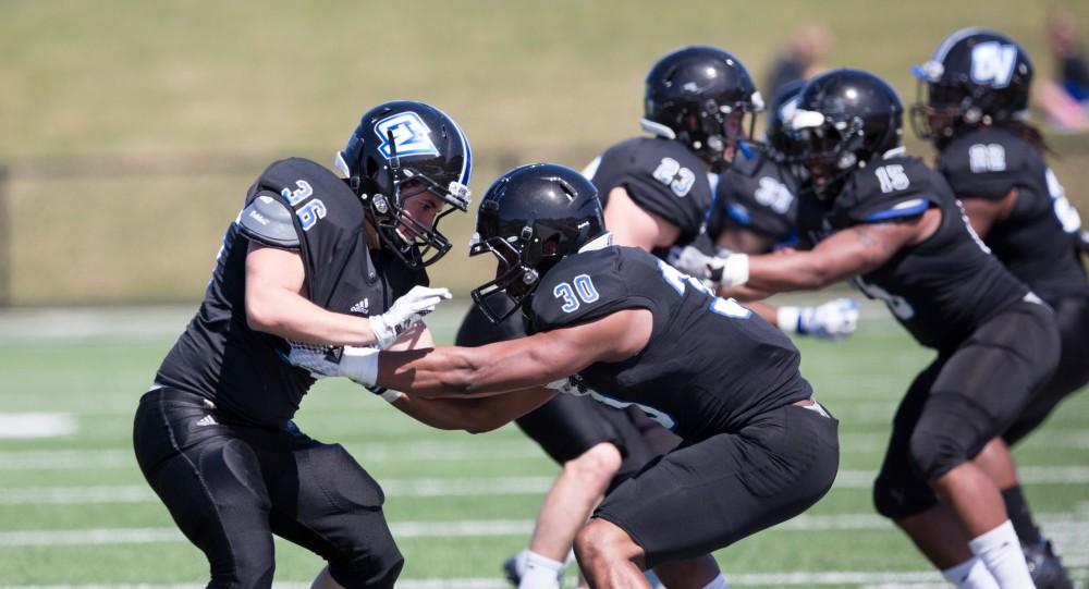 GVL / Kevin Sielaff - Daigien Morgan (30) runs a blocking drill on the sideline. The 2016 Grand Valley State Spring Classic is hosted at Lubbers Stadium on Saturday, April 16, 2016.