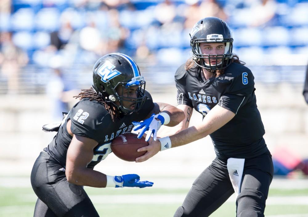 GVL / Kevin Sielaff - Terrell Dorsey (22) takes a handoff from Bart Williams (6) and heads upfield. The 2016 Grand Valley State Spring Classic is hosted at Lubbers Stadium on Saturday, April 16, 2016.