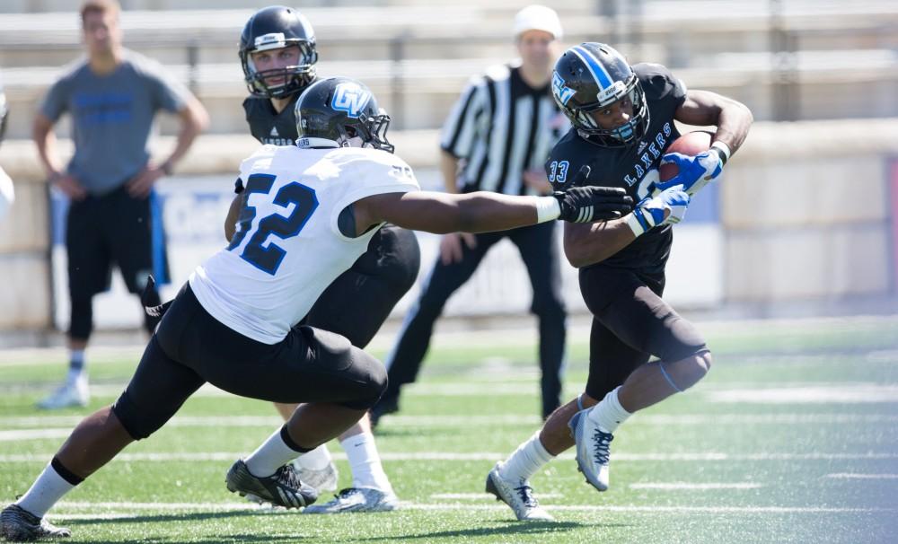 GVL / Kevin Sielaff - Christian Lumpkin (33) tip toes the sideline as he carries the ball upfield. The 2016 Grand Valley State Spring Classic is hosted at Lubbers Stadium on Saturday, April 16, 2016.