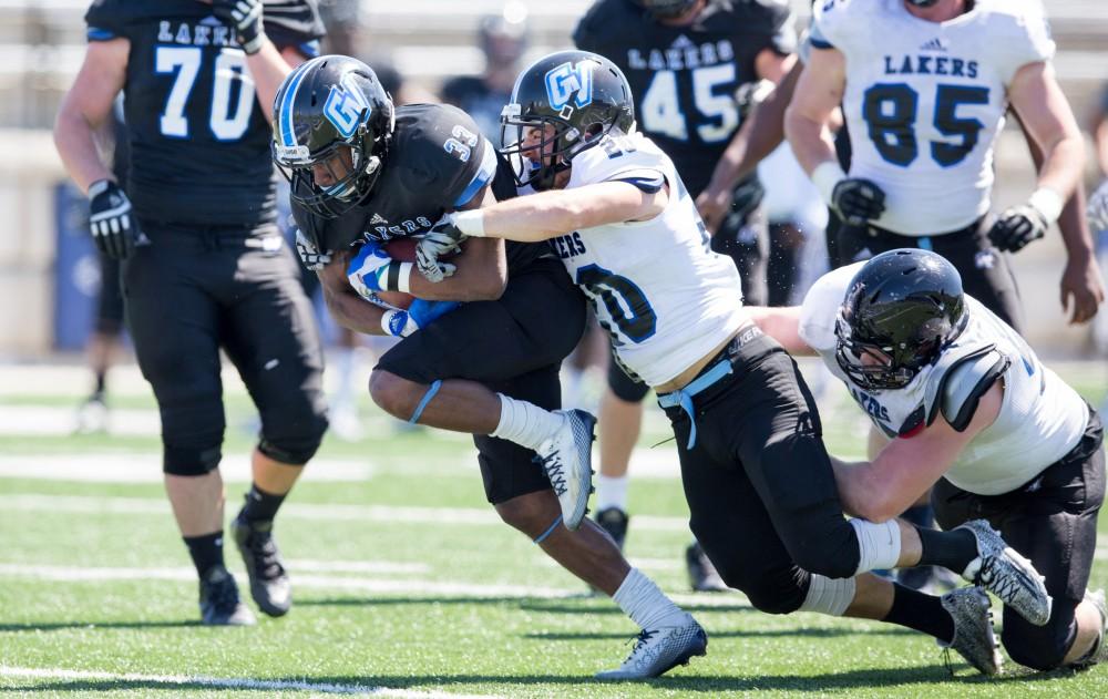 GVL / Kevin Sielaff - Christian Lumpkin (33) rushes upfield but is tackled from behind. The 2016 Grand Valley State Spring Classic is hosted at Lubbers Stadium on Saturday, April 16, 2016.