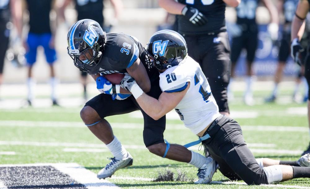 GVL / Kevin Sielaff - Christian Lumpkin (33) rushes the ball upfield but is tackled from behind. The 2016 Grand Valley State Spring Classic is hosted at Lubbers Stadium on Saturday, April 16, 2016.