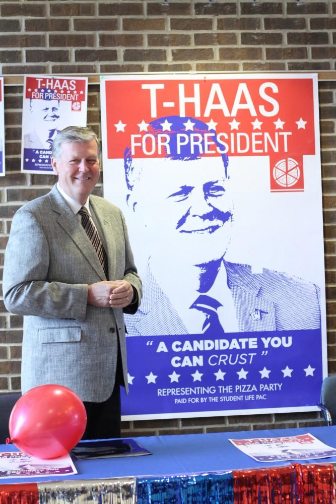 GVL / Kasey Garvelink - President T. Haas poses with his posters at the Student Life event on Apr. 1, 2016 in Allendale. 
