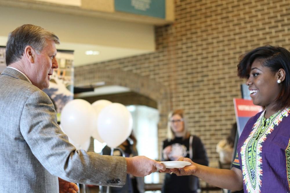 GVL / Kasey Garvelink - During a Student Life event, President T. Haas helps hand out pizza to students on Apr. 1, 2016 in Allendale. 