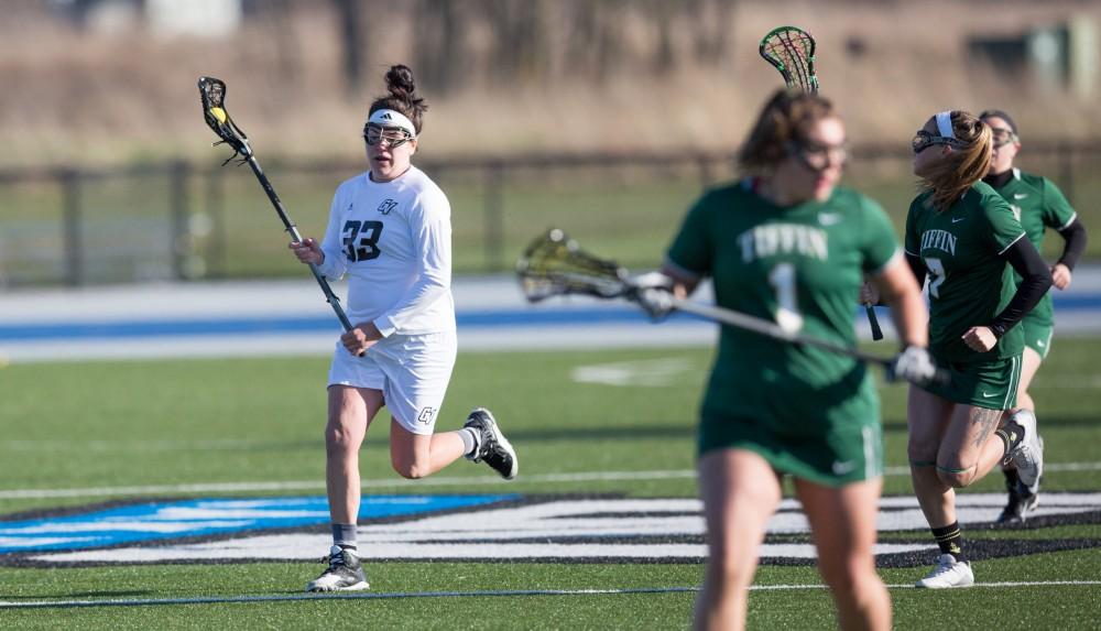 GVL / Kevin Sielaff – Caitlin Wojichowski (33) carries the ball up field. The Lakers take the victory over Tiffin University Friday, April 1, 2016.