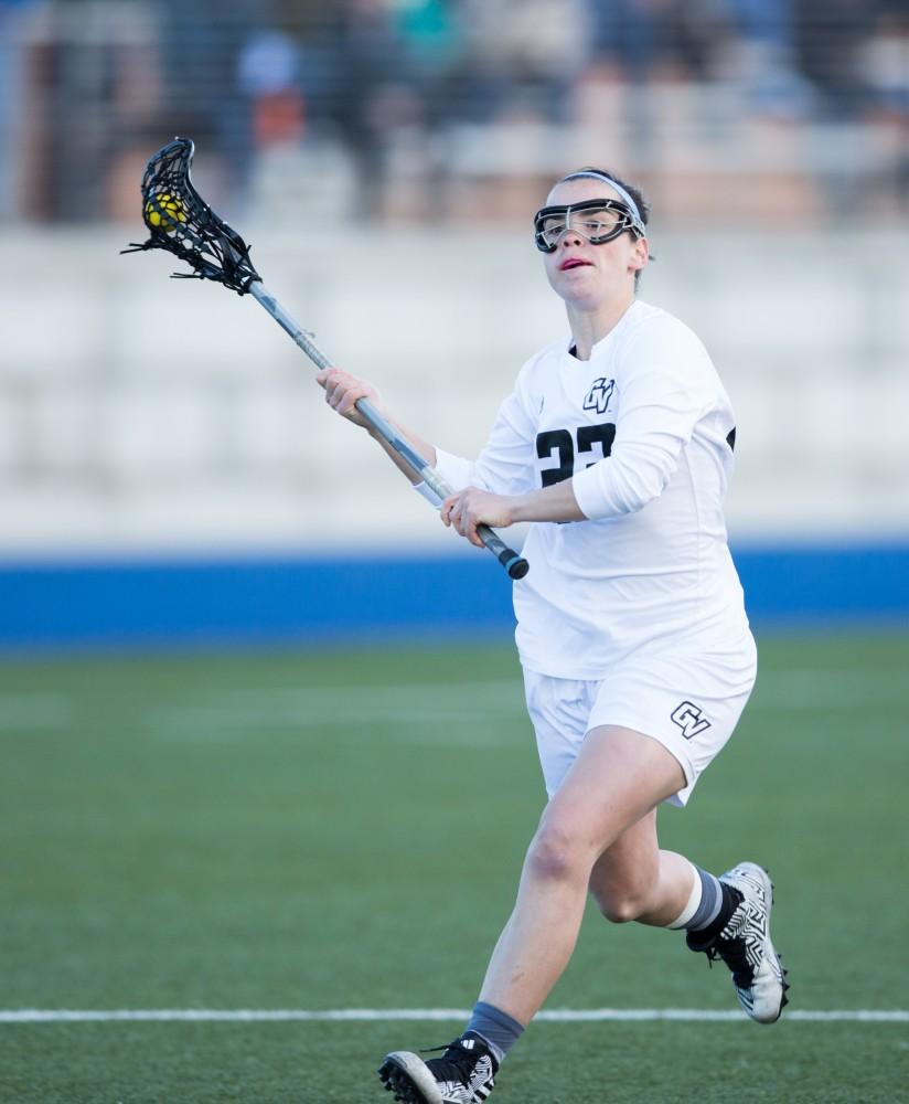 GVL / Kevin Sielaff – Carolyn Kraus (23) carries the ball in on Tiffin's net and tries a shot. The Lakers take the victory over Tiffin University Friday, April 1, 2016.