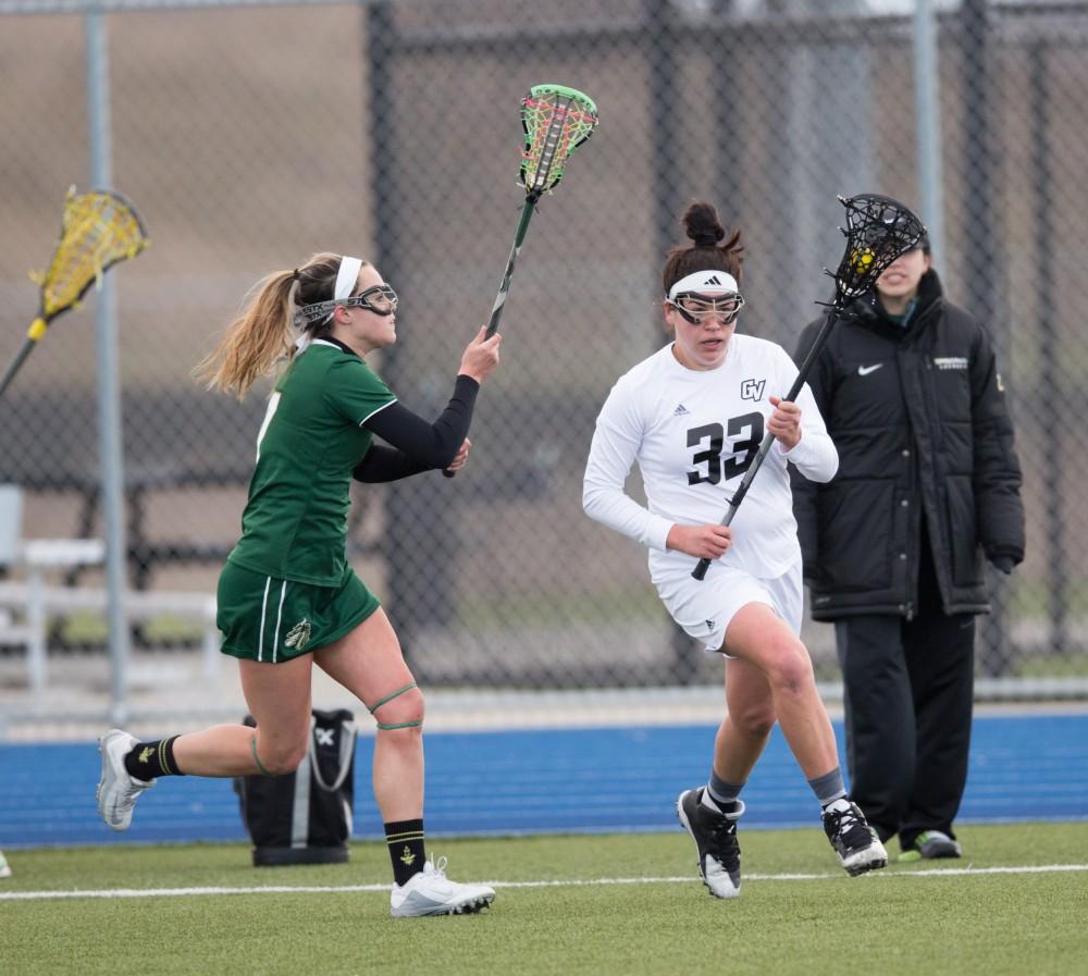 GVL / Kevin Sielaff – Caitlin Wojichowski (33) holds the ball at mid-field and carries it into Tiffin's zone. The Lakers take the victory over Tiffin University Friday, April 1, 2016.