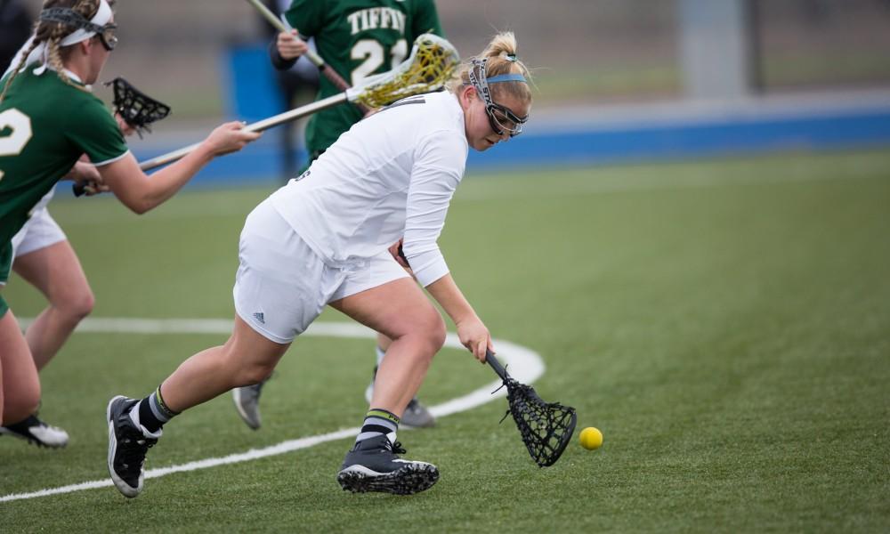 GVL / Kevin Sielaff – Kira Dosenberry (4) picks up a loose ball and carries it up field. The Lakers take the victory over Tiffin University Friday, April 1, 2016.