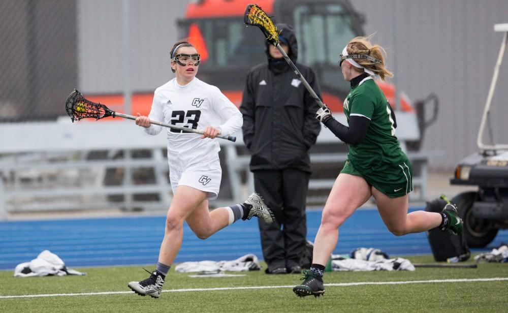 GVL / Kevin Sielaff – Carolyn Kraus (23) looks to pass the ball as she moves up Tiffin's sideline. The Lakers take the victory over Tiffin University Friday, April 1, 2016.