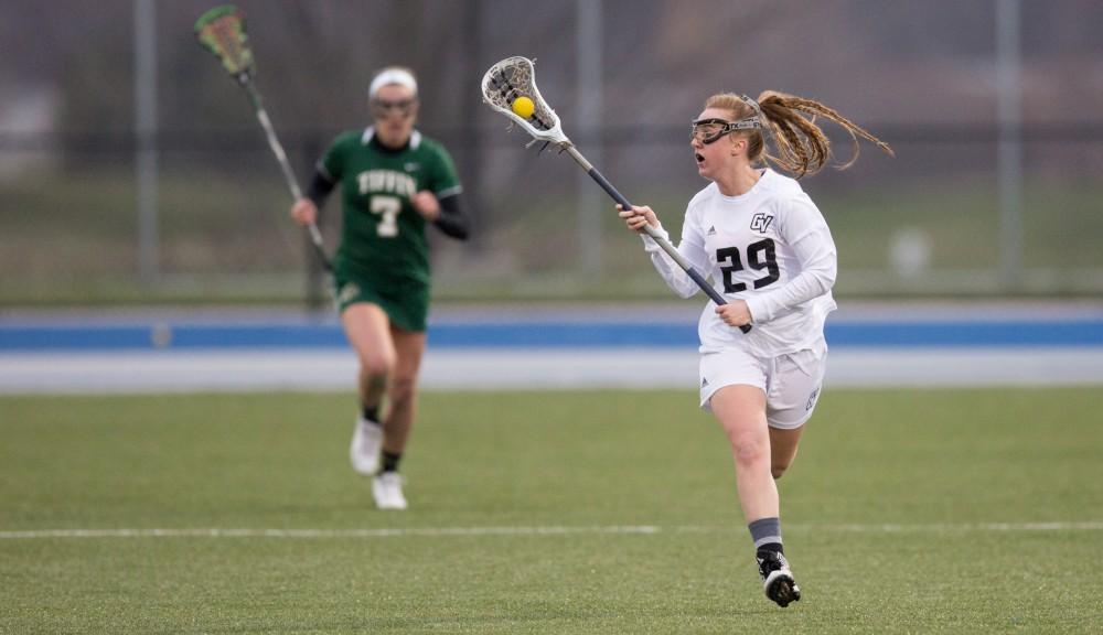 GVL / Kevin Sielaff – Adrianna Smith (29) carries the ball up field. The Lakers take the victory over Tiffin University Friday, April 1, 2016.