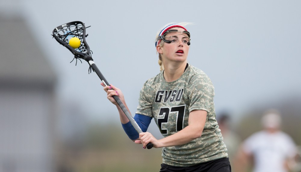 GVL / Kevin Sielaff - Danielle Tunnell (27) holds the ball in Lake Erie's zone and looks to pass. Grand Valley defeats Lake Erie College with a final score of 19-2 on Friday, April 29, 2016 in Allendale. 